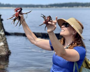 Our Education Director, Rachel, holding up two very crabby Kelp Crabs.